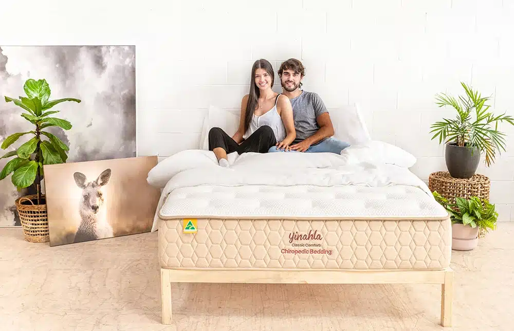 Couple sitting on Classic Comfort Mattress