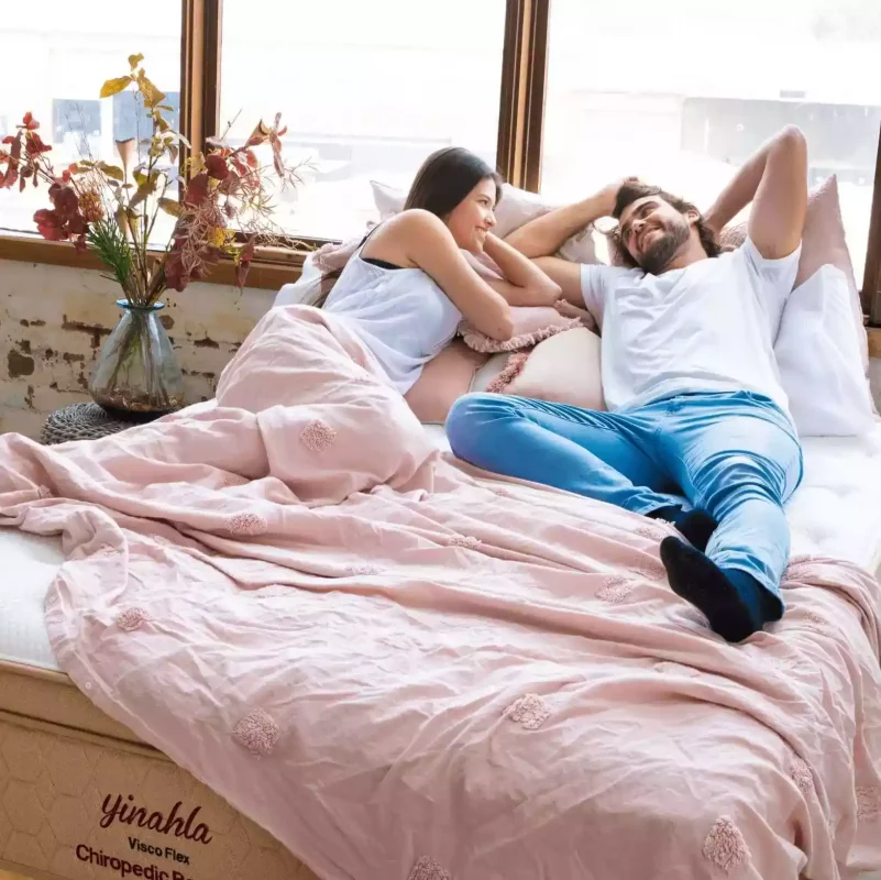 Couple relaxing on Yinahla’s Australian-made mattresses